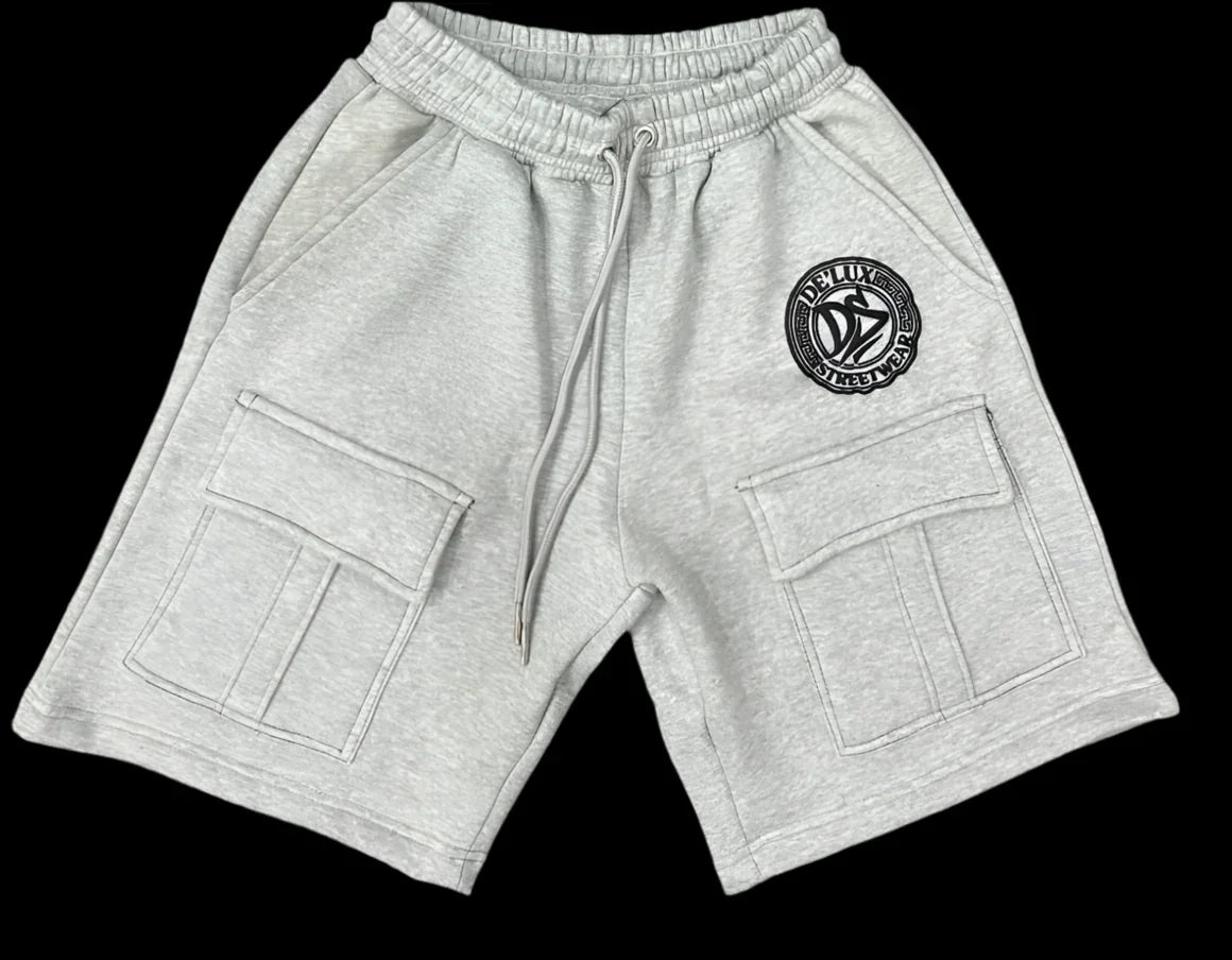Light grey De’LuX StreetWear cargo shorts with logo patch and large front pockets on black background
