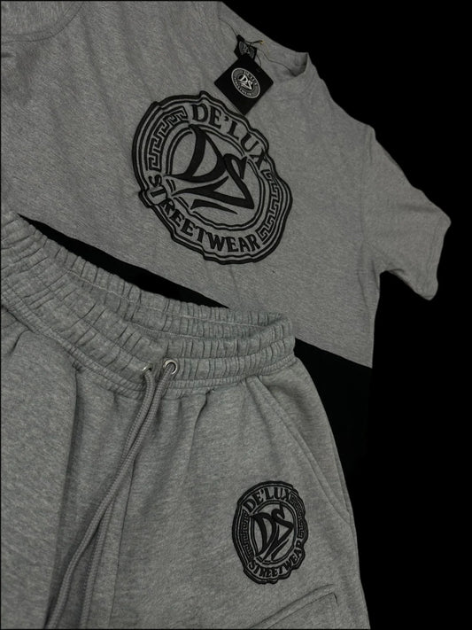 De’LuX StreetWear grey matching set with logo on t-shirt and shorts, laid on black background